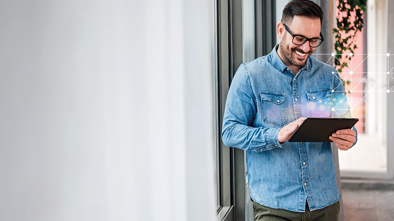man smiling and working on tablet