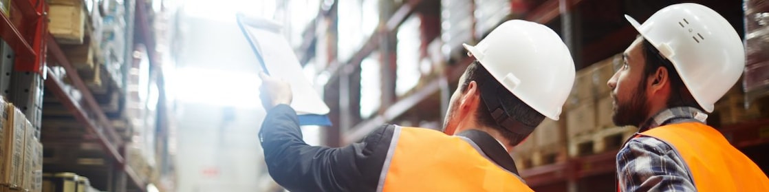 Worker inspecting a large warehouse