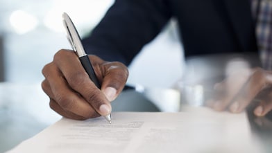 Man is signing the document