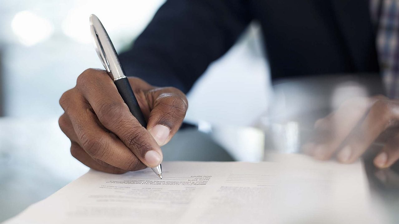 Man is signing the document