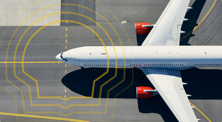 Aerial view of a plane on a runway overlayed with the Shell Pecten