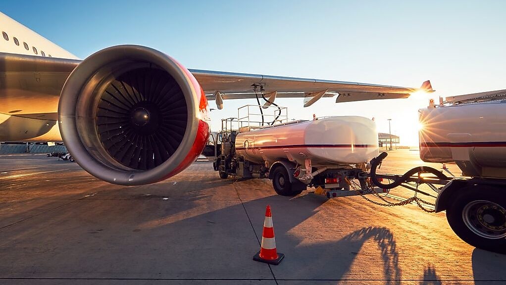 Airplane refuelling at sunset