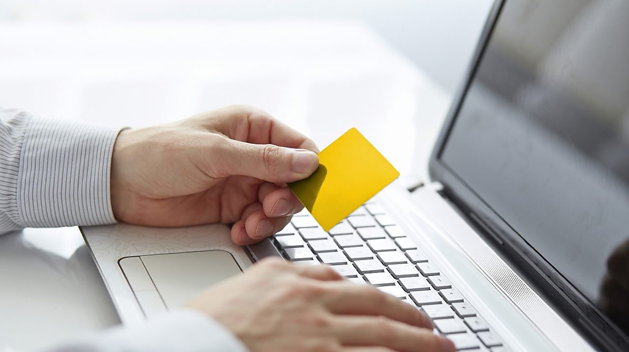 Man holding shell card in hand