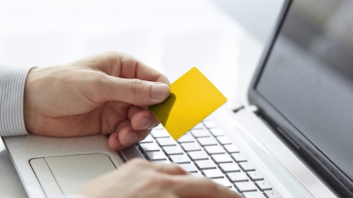 Man with the card on the laptop