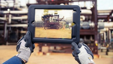 A tablet being held to show a structure in the horizon