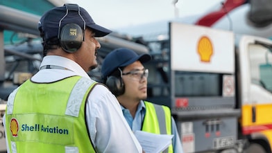 Two engineers looking at the horizon and observing something