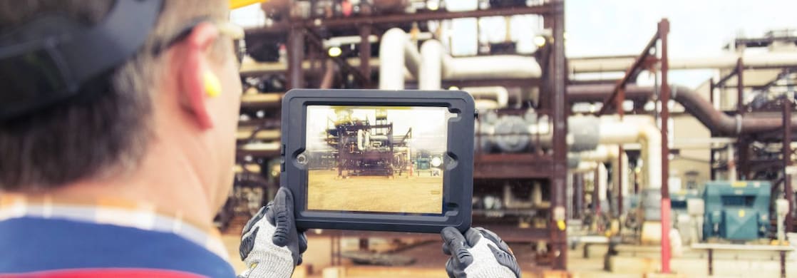 A tablet being held to show a structure in the horizon