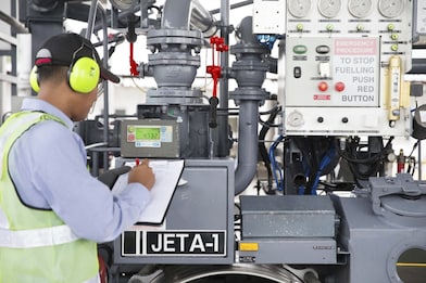 A staff checking the fueling status and operations