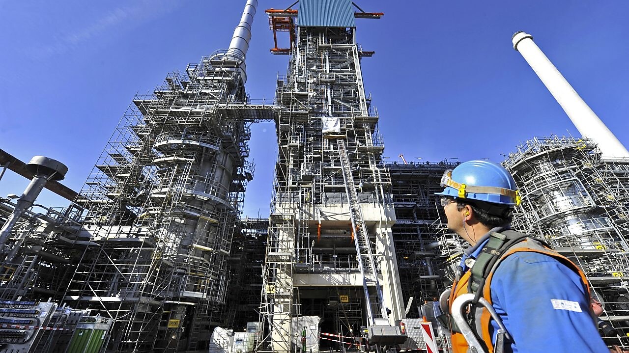 Man looking at refinery construction site
