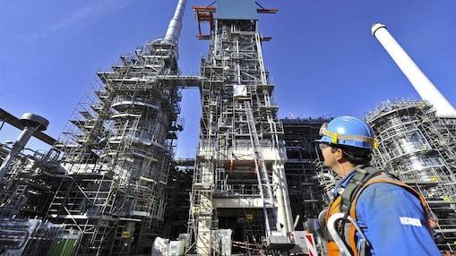 Man looking at refinery construction site