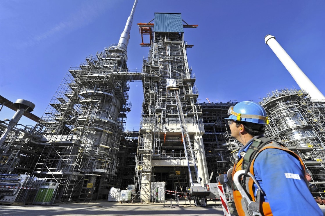 An engineer looking above to see the building being built