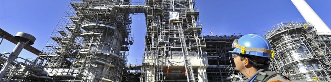 An engineer looking above to see the building being built
