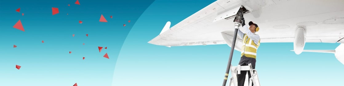 Man attaching fuel pipe to aircraft