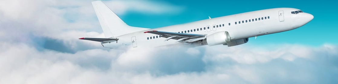Commercial airplane jetliner flying above clouds