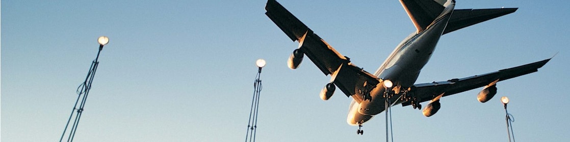 Underside of an aircraft descending on to an airstrip