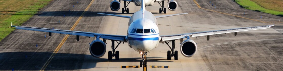 A fleet of aircraft queuing on a runway