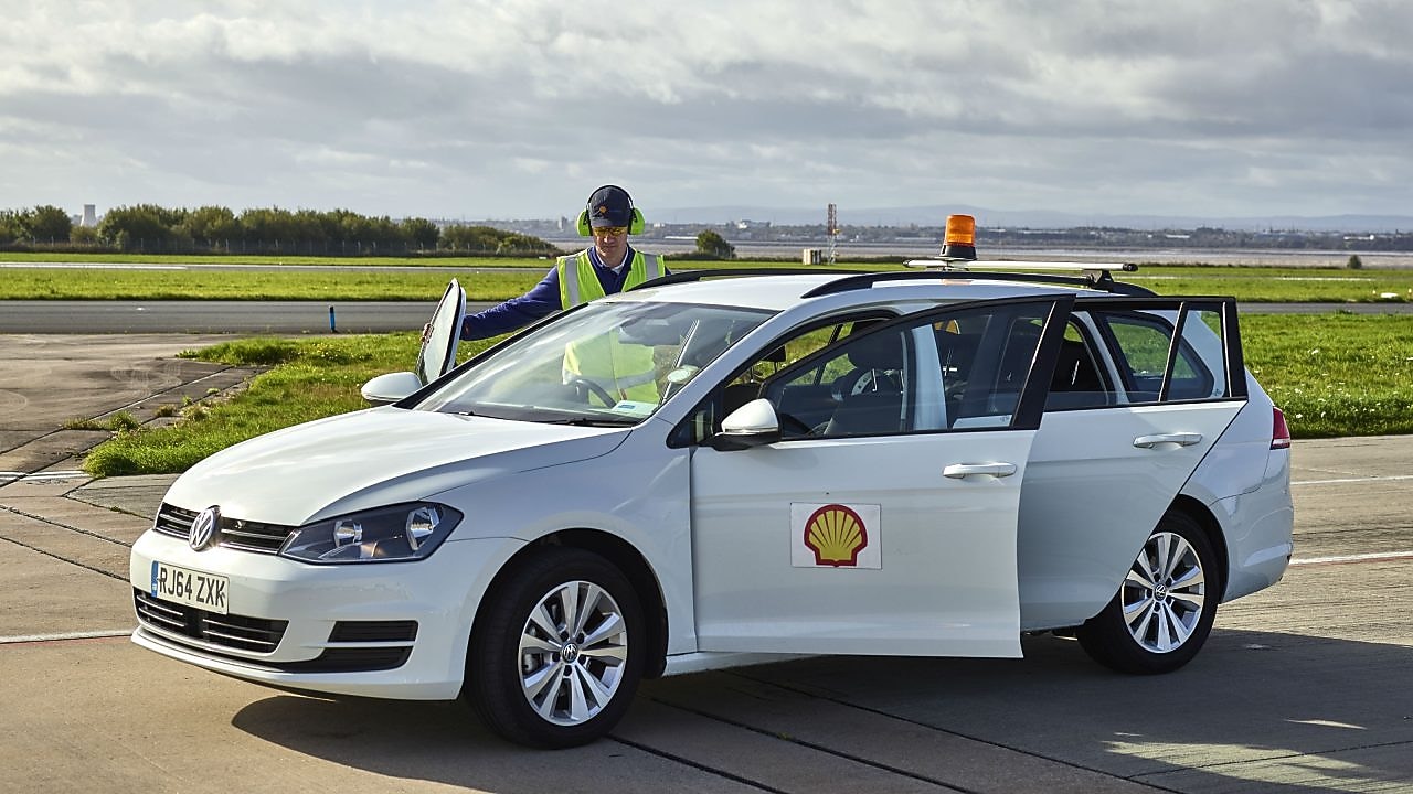 Man checking shell car