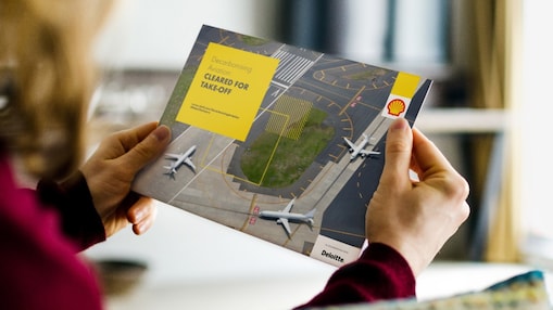 holding a booklet in hand