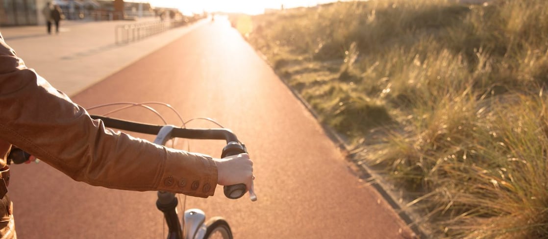 man holding a bycycle