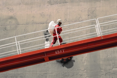 Shell worker turns valve while facilitating dioxin removal.