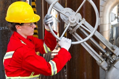 Shell employee turns a valve during a carbon dioxide purification process.