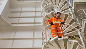 Worker watches from the stairs.