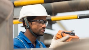 Employee conducts inspection at LNG tank used for aromatic saturation