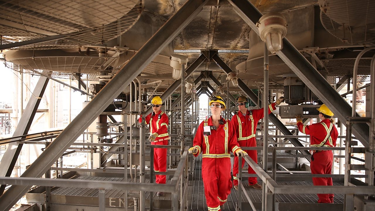 4 shell employees work to improve the aromatic saturation