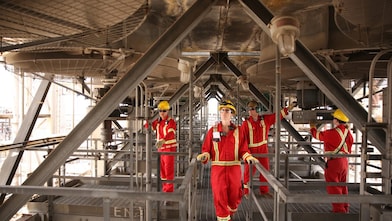 4 shell employees work to improve the aromatic saturation