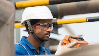 Employee conducts inspection at LNG tank used for aromatic saturation