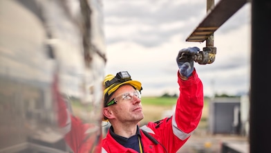 Technician checking deluge nozzle next to exchanger