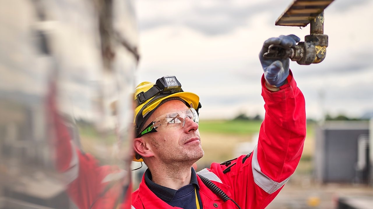Technician checking deluge nozzle next to exchanger
