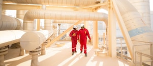 Operators reviewing refinery technology performance