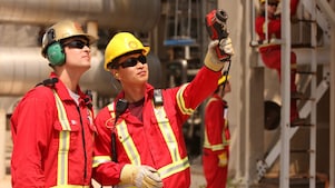 Employees surveying claus process reactor