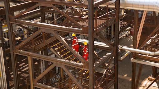 two employees walking up the stairs at the Quest Carbon Capture and Storage facility