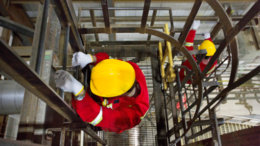 Workers climb a ladder within a portion of the Quest Carbon Capture unit