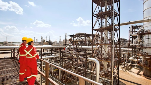 Workers survey a portion of the Quest Carbon Capture and Storage unit at the Scotford Upgrade
