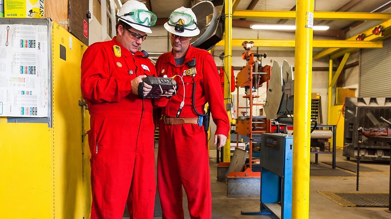 Employees review natural gas purification performance of Shell plant