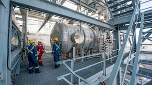 Employees running natural gas processing inspections in Alberta plant