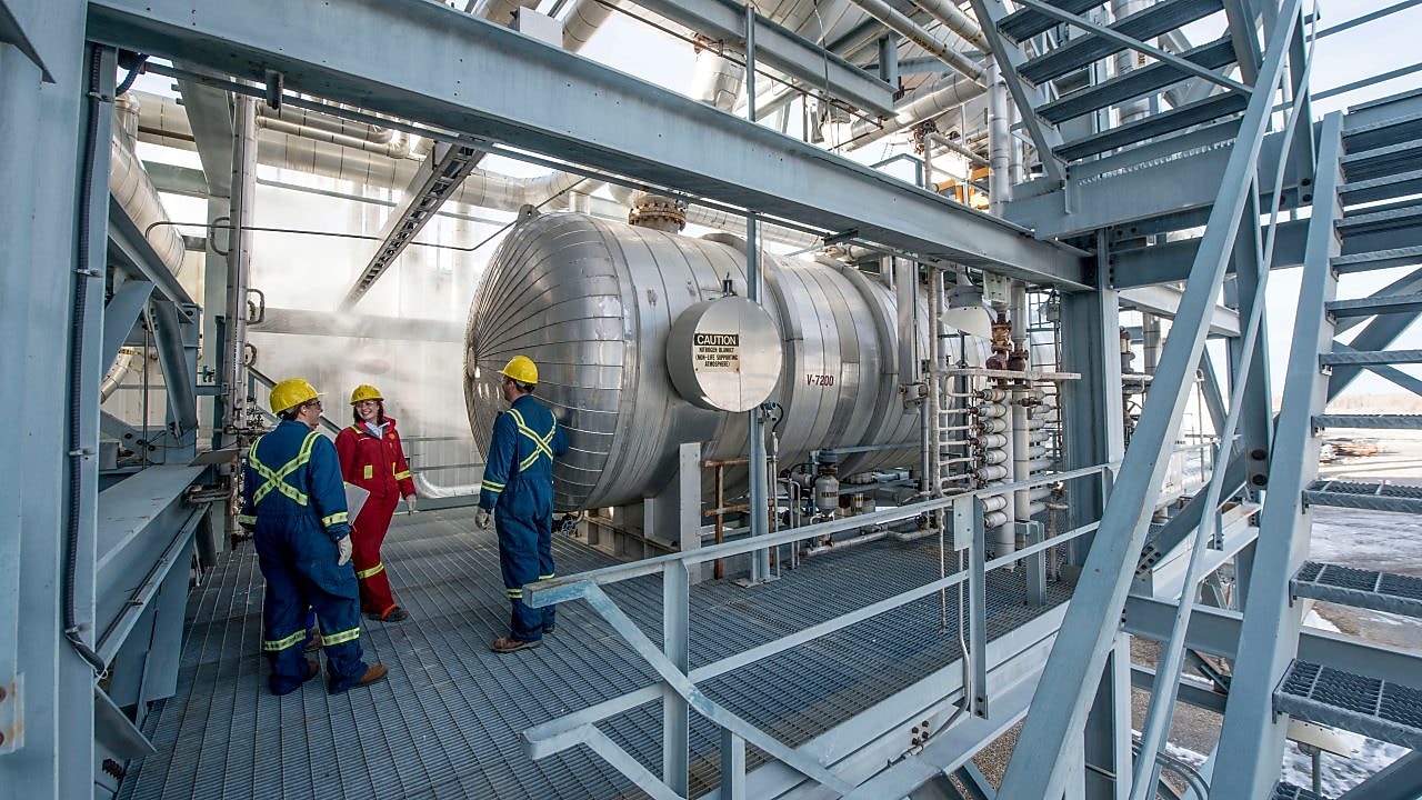 Employees running natural gas processing inspections in Alberta plant