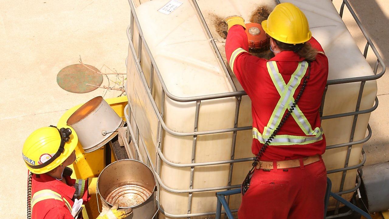 Two people working on site