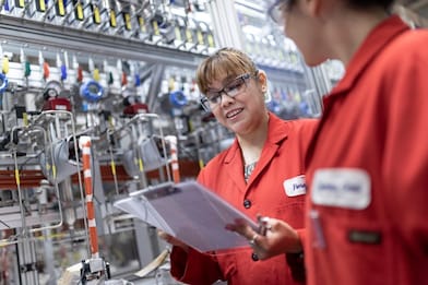 Shell employees working next to refinery equipment