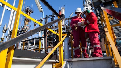Two shell workers at the site