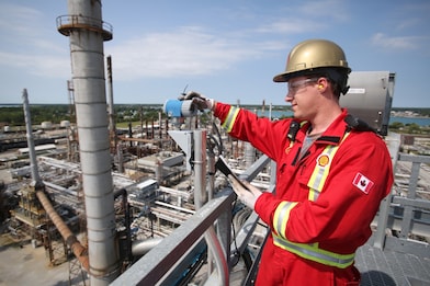 A Shell employee maintains an FCC unit.