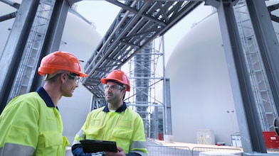Shell employees in front of structure having technical conversation