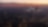 Commercial airplane flying over big city at dusk