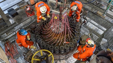 Four engineers working on a pernis refinery machine