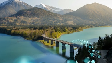 Aerial view of a bridge over a river and mountains