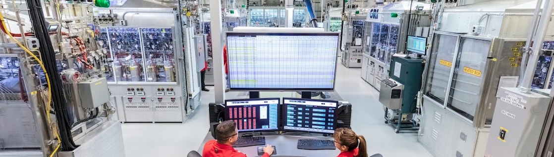 Shell workers review AI for energy sectors together, in the office.