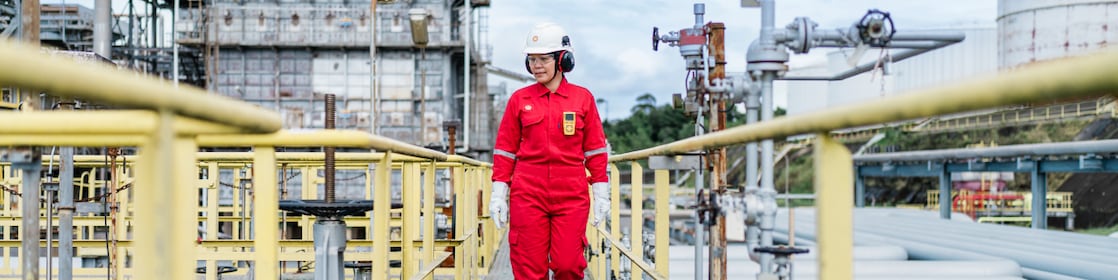 Sell employee walks through refinery during the daytime